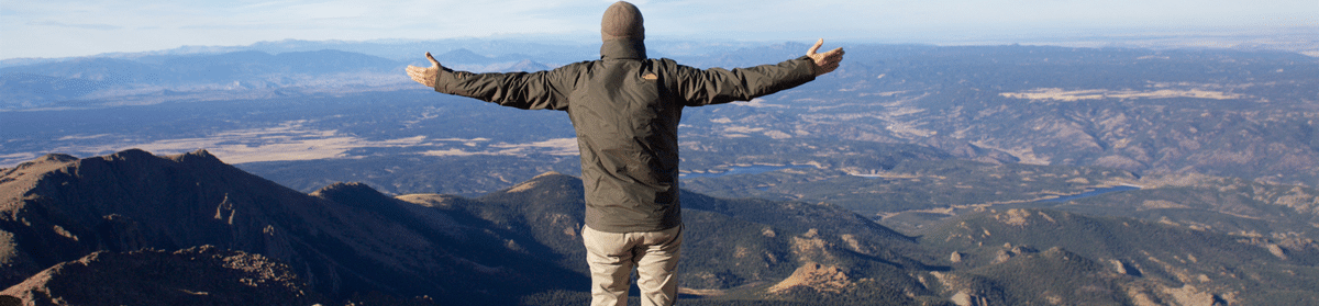 man-standing-on-top-of-pikes-peak-colorado-with-arms_151211334_M